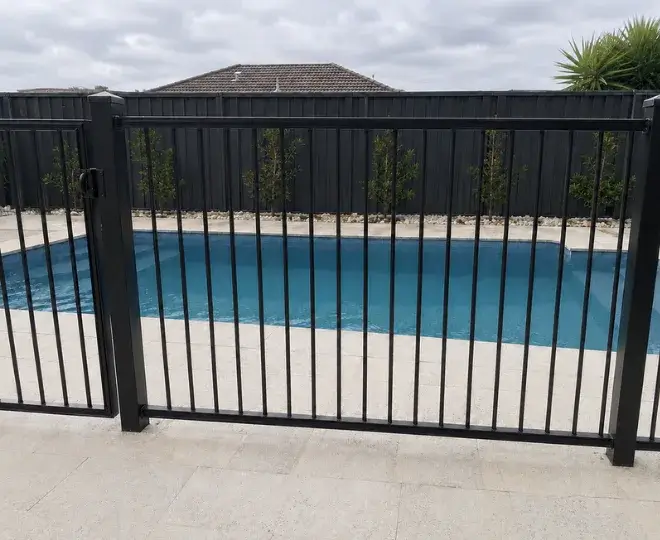 An aluminium pool fence surrounding a swimming pool in Newtown