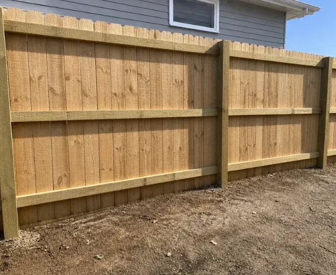 A rustic natural timber fence at the side of a property in East Toowoomba
